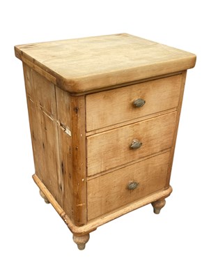 Lot 2139 - An old pine chest of three drawers, on turned...