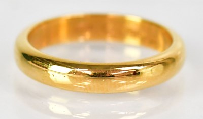 Lot 739 - A 22ct yellow gold wedding band, size R,...
