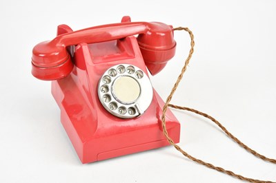 Lot 1335 - A vintage red bakelite telephone.
