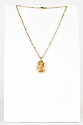 Lot 871 - A 9ct yellow gold locket with floral engraving,...