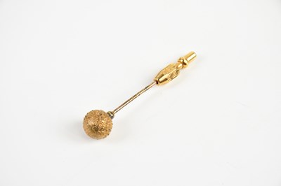 Lot 1618 - A yellow metal tie slide with bark effect orb,...
