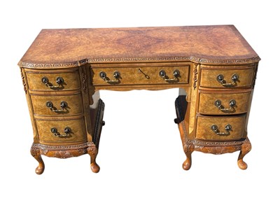 Lot 2082 - A Queen Anne style walnut knee hole desk, with...