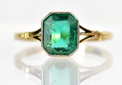 Lot 747 - An 18ct yellow gold ring set with a green...