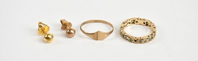 Lot 1605 - A 9ct gold wedding band set with clear stones,...