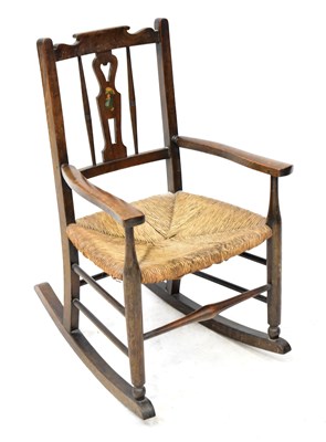 Lot 110 - ATCRAFT; an oak child's rocking chair, with...