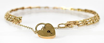 Lot 814 - A 9ct yellow gold three bar gate bracelet with...