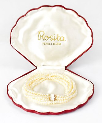 Lot 880 - A three-strand pearl necklace with a 14ct...