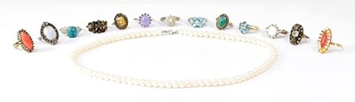 Lot 796 - A 9ct yellow gold ring set with blue and white...