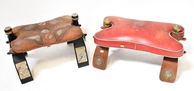 Lot 112 - Two Middle Eastern saddle stools, one with...