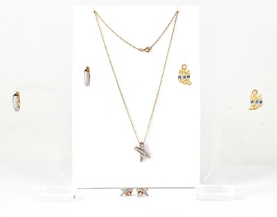 Lot 930 - A 9ct yellow gold X-shaped pendant, set with...