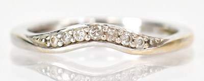 Lot 767 - An 18ct gold curved band ring set with a row...