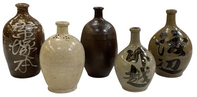 Lot 646 - Five Japanese tokkuri stoneware sake bottle...