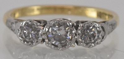 Lot 1166 - An 18ct yellow gold platinum diamond three...