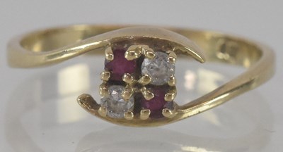 Lot 1179 - A 9ct yellow gold ruby and diamond crossover...