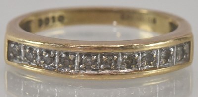 Lot 1181 - A 9ct yellow gold diamond half eternity ring,...