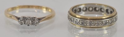 Lot 1182 - A yellow metal diamond three stone ring, size...