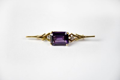Lot 805 - A 9ct gold brooch set with emerald cut purple...