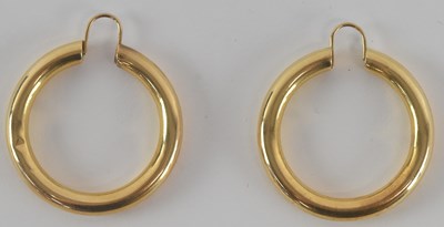 Lot 1258 - A pair of yellow metal hoop earrings, both...