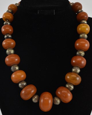Lot 1250 - An African white metal and amber effect bead...