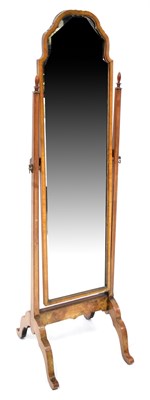 Lot 136 - A walnut framed cheval mirror with shaped top,...