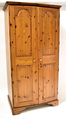 Lot 83 - A seven-piece pine bedroom suite comprising a...