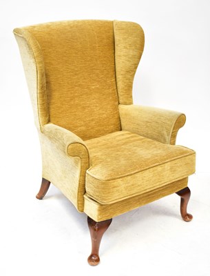 Lot 118 - A wingback armchair, raised on cabriole...