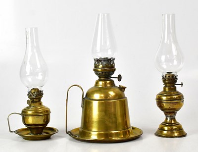 Lot 147 - Three vintage brass oil lamps, two with carry...