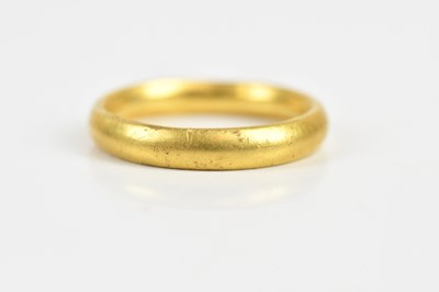 Lot 1651 - A yellow metal wedding band, size P,...