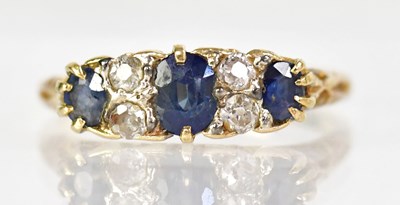 Lot 751 - An 18ct yellow gold ring claw set with three...