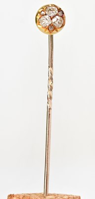Lot 932 - A yellow metal tie pin set with three diamonds...