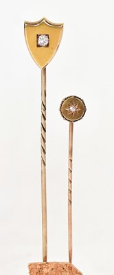 Lot 933 - A yellow metal tie pin set with a central...