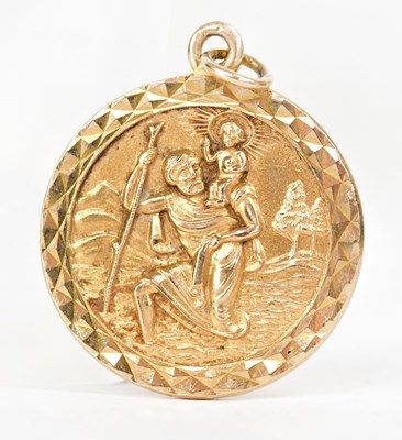 Lot 868 - A 9ct gold St Christopher pendant of circular...