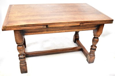 Lot 34 - An oak refectory draw-leaf table of peg...