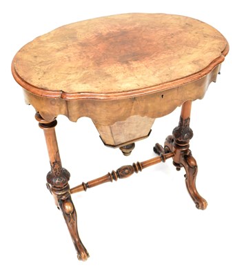 Lot 69 - A Victorian walnut sewing table, with a shaped...