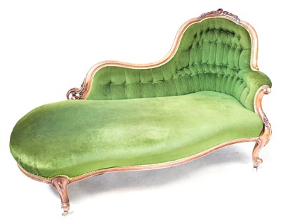 Lot 130 - A Victorian carved walnut chaise longue with...