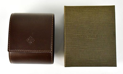 Lot 993 - PATEK PHILIPPE; a branded leather watch travel...