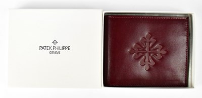 Lot 367 - PATEK PHILIPPE; a branded burgundy leather...