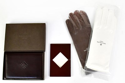 Lot 368 - PATEK PHILIPPE; a branded brown leather credit...