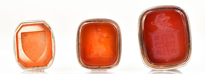 Lot 935 - Two yellow metal fobs set with carved...