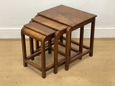 Lot 539 - A walnut Art Deco nest of three tables, the...