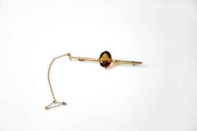 Lot 807 - A yellow metal bar brooch set with an oval...