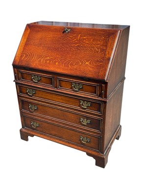 Lot 2260 - A reproduction 18th century design oak bureau,...