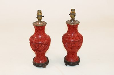 Lot 1250 - A pair of Chinese red lacquered profusely...