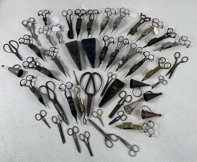 Lot 1005 - A large collection of candle snuffers, wick...