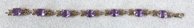 Lot 368 - A 9ct yellow gold and amethyst bracelet, the...