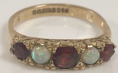 Lot 399 - A 9ct yellow gold five stone garnet and opal...