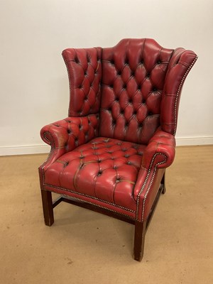 Lot 517 - A button upholstered red leather wingback...