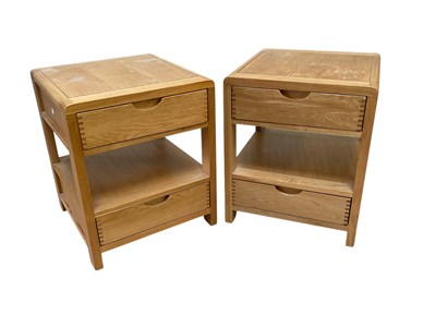 Lot 2316 - ERCOL; a pair of modern light oak bedside...