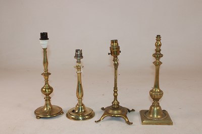 Lot 1209 - A group of four early 20th century brass table...