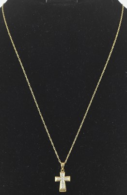 Lot 1249 - A 9ct gold white stone clad cross pendant on a...